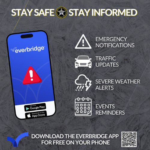 Promotional poster for the Everbridge mobile app featuring a smartphone displaying the app interface. Includes icons for emergency notifications, traffic updates, severe weather alerts, and event reminders. Text advises downloading the app for free on your phone with App Store and Google Play logos displayed. A QR code is positioned at the bottom right for easy access.