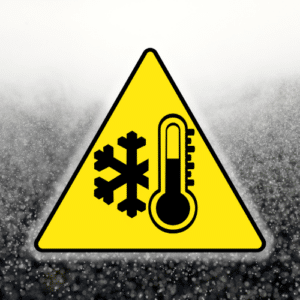 Caution sign yellow in color featuring black graphics that show a snow flake and thermometer on a icy backbround.
