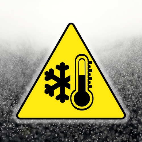 Caution sign yellow in color featuring black graphics that show a snow flake and thermometer on a icy backbround.