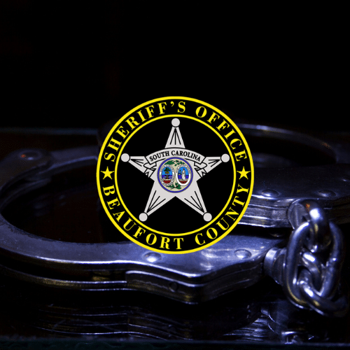 Beaufort County Sheriff's Office logo centered on a photo of handcuffs with a dark background.